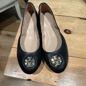 Tory Burch black and gold flats.